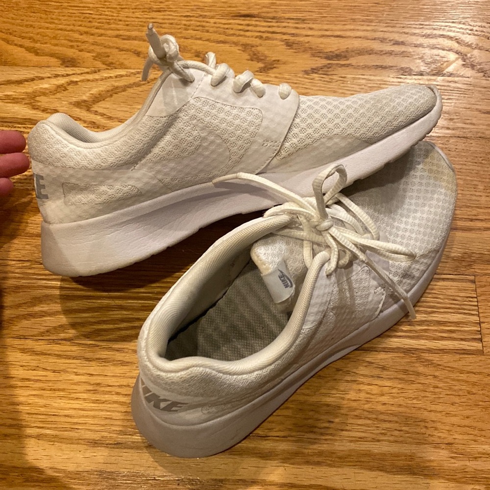 Well worn Nike white sneakers